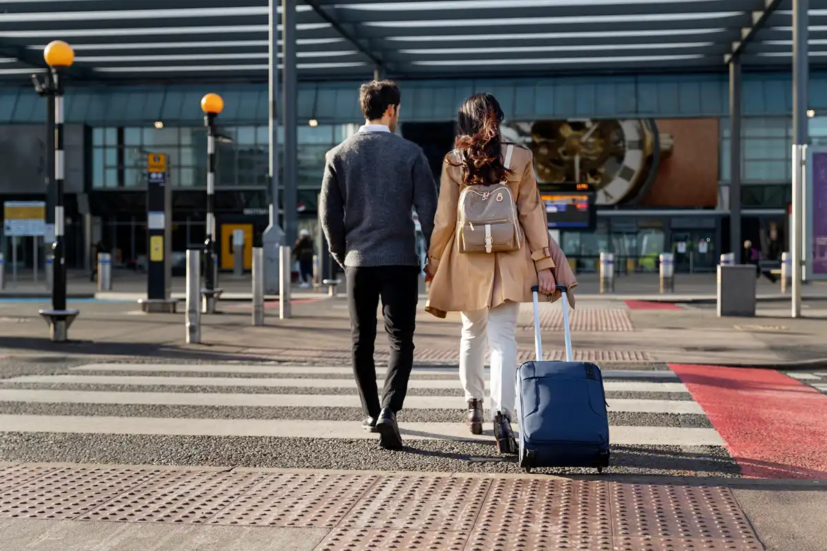 Couples going to airport with luggage